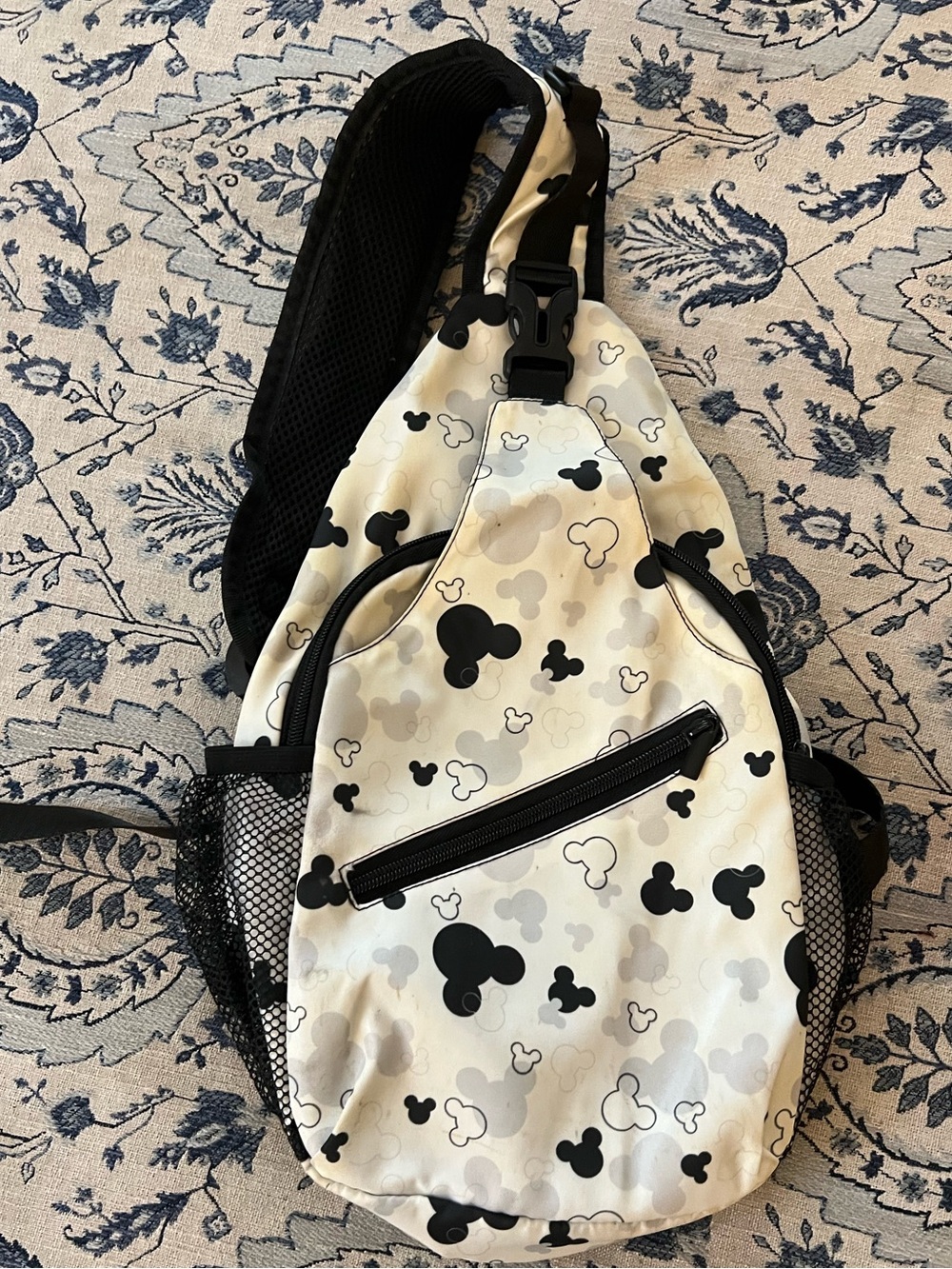 Mickey Mouse-patterned sling backpack w/all-over black, white, and grey logo